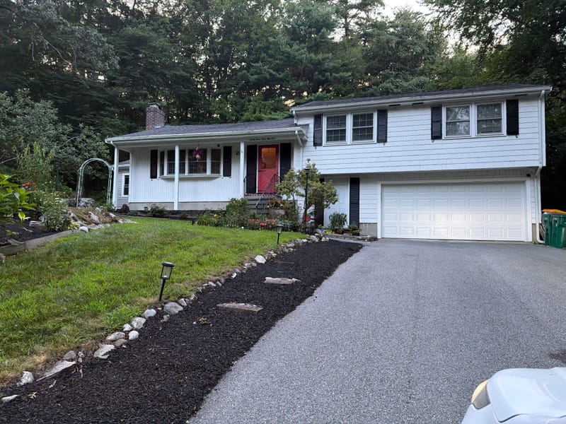 Split-level house in Acton, MA with its new white 16-foot insulated Amarr Olympus garage door